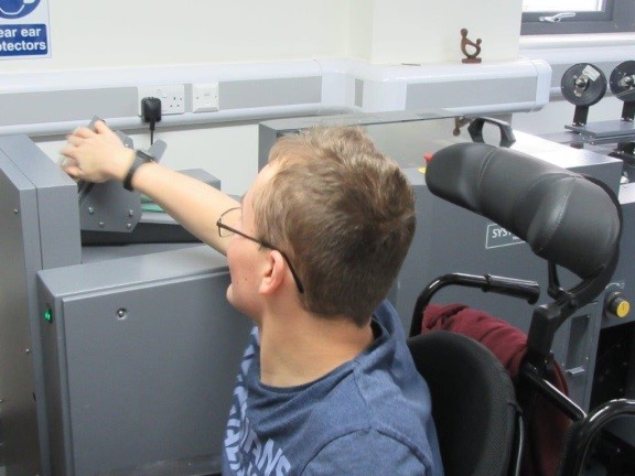 Student (Toby) creating booklets suing the new booklet making machine