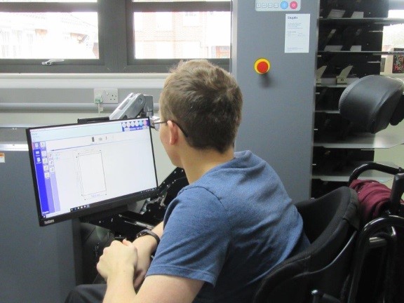 Student (Toby) programing the booklet maker