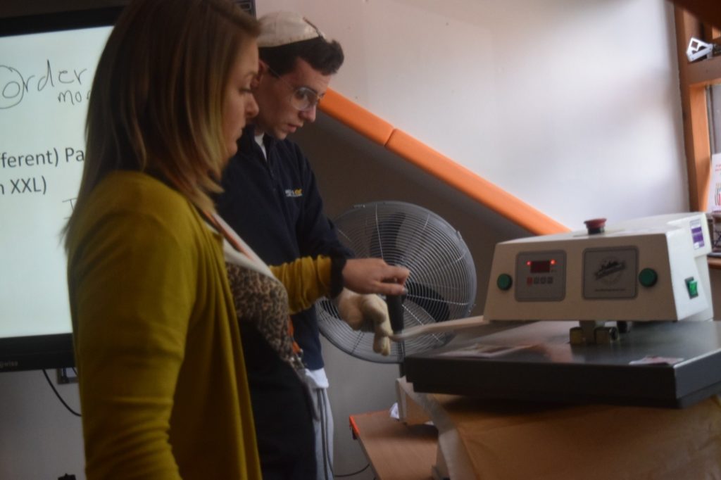 Students using a heat press to print t-shirt