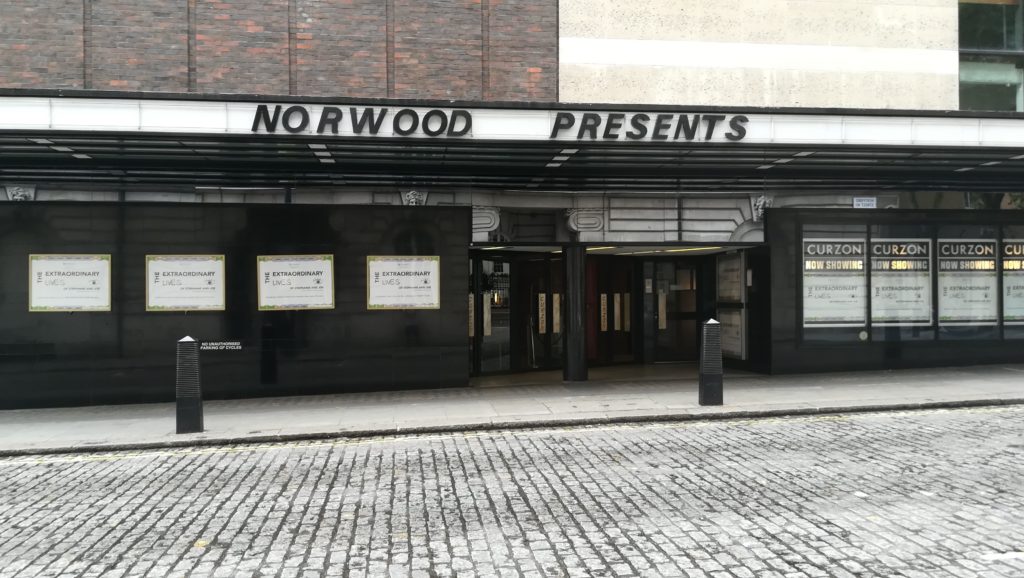Central London cinema, with full-size posters plastered all round.
