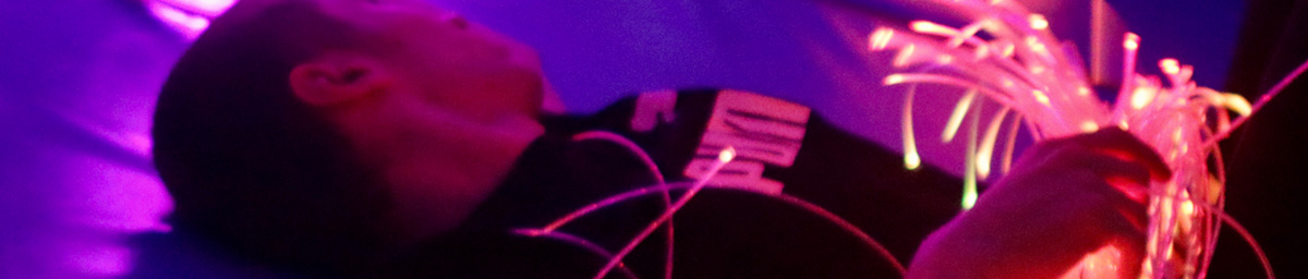 Young man lying down enjoying a sensory room