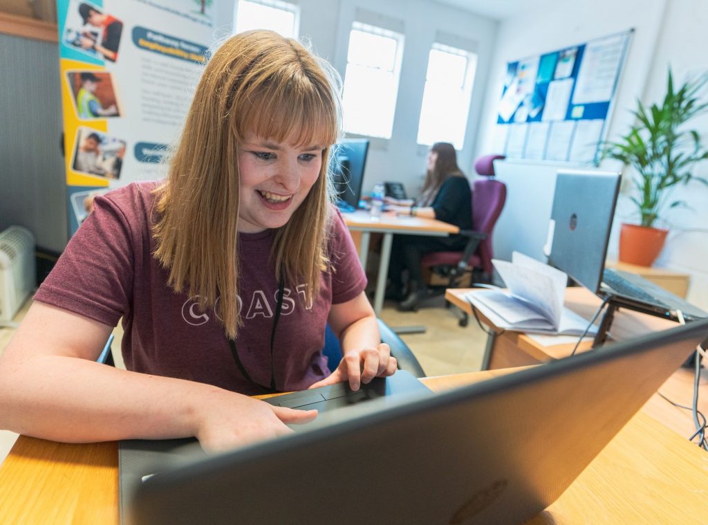 Student Finola working in the Comms office