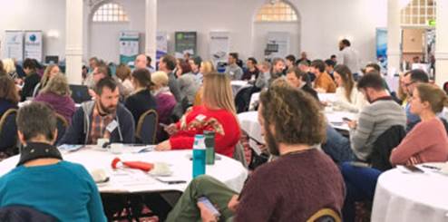 Groups of people sitting around tables at the TechAbility Conference