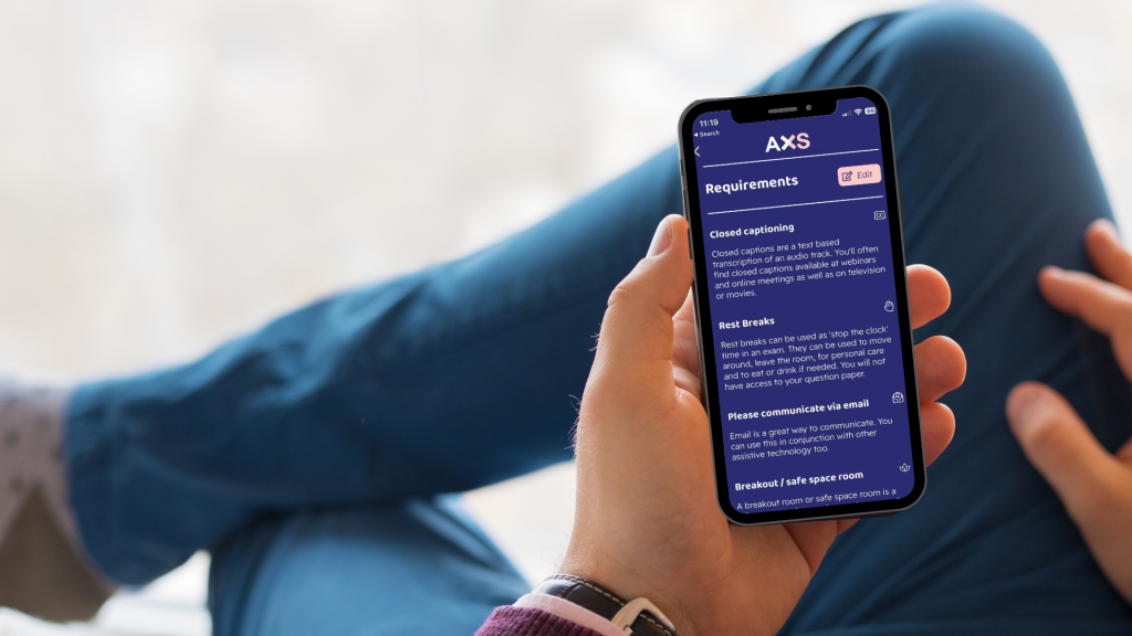 A man sitting, holding a mobile phone. The AXS Passport form is displayed on his phone.  