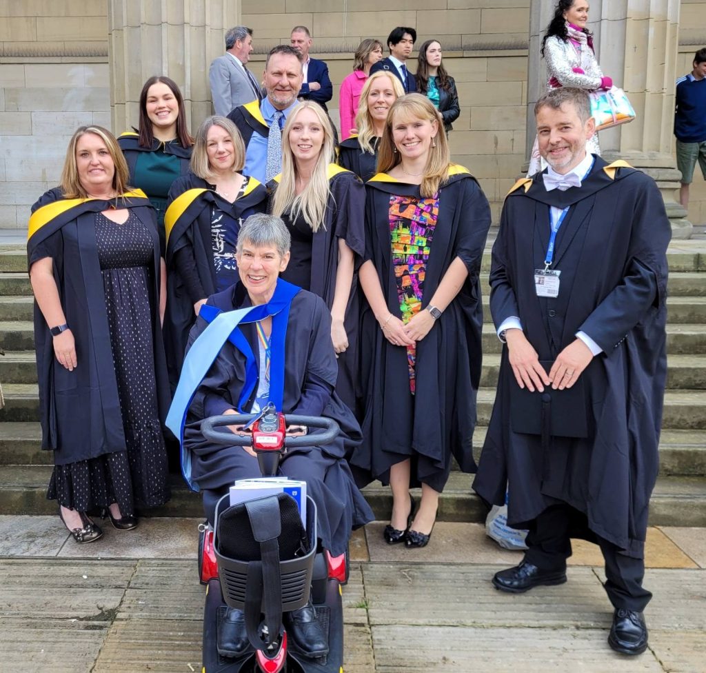 Group of MSc EduAT graduates with programme leads, Rohan Slaughter and Annalu Waller taken on the Caird Hall steps following the 2024 graduation ceremony