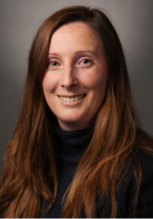 Photo of Kayleigh Hunt, a lady with long brown hair. She is smiling