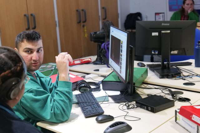 Student, sitting at a desk in front of the new Karten Network centre computers